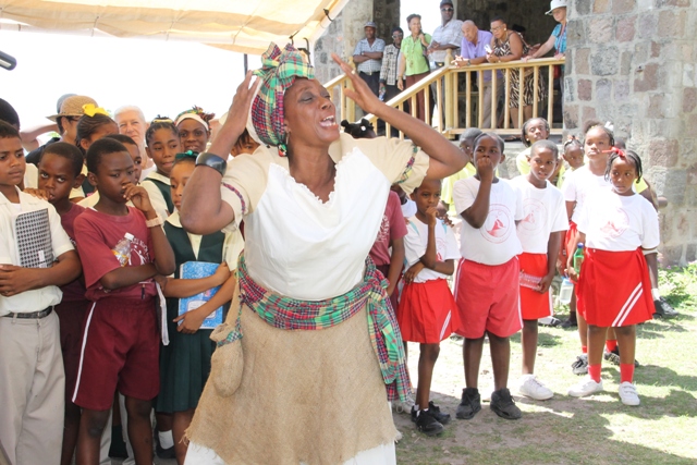 Adela Meade delivers a dramatic presentation depicting a day in the life of a slave at the New River Estate for students and seniors at New River Estate on May 18, 2016, at an event hosted by the Nevis Historical and Conservation Society and the Ministries of Tourism and Agriculture in observance of International Museum Day
